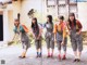 A group of young women standing in front of a building.