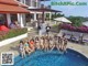 A group of people posing for a picture in a swimming pool.