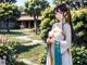 A woman in a kimono standing in a garden.