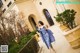 A woman in a blue dress is walking down some steps.